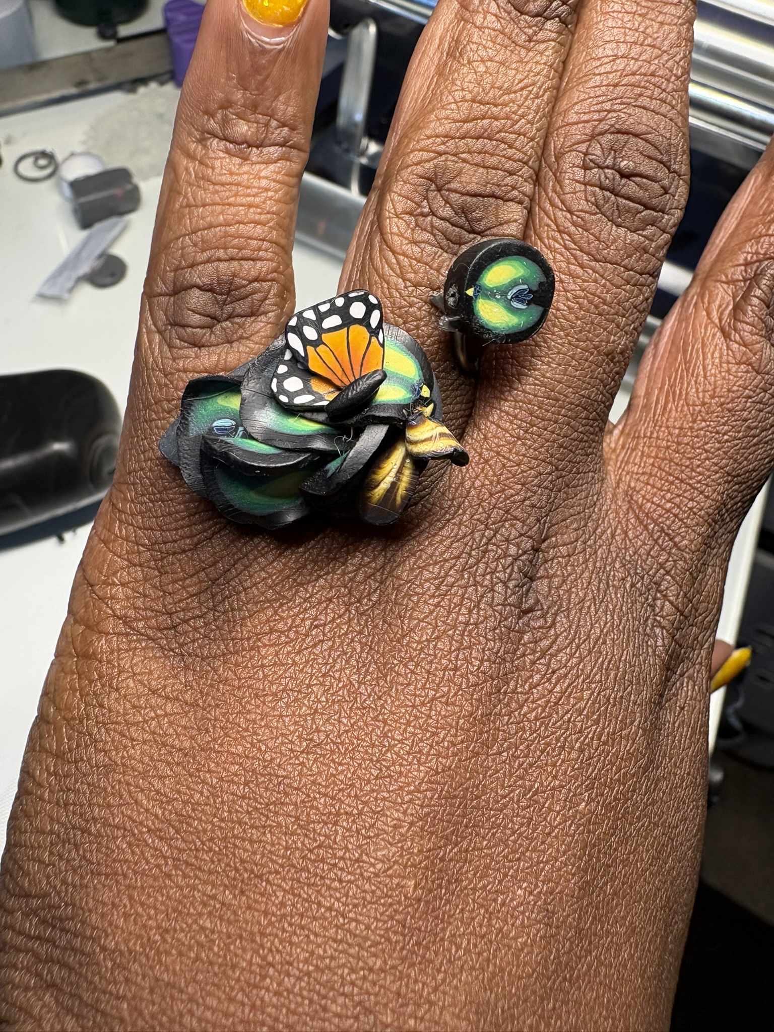 Sculptural rings with a monarch wing, on the hand